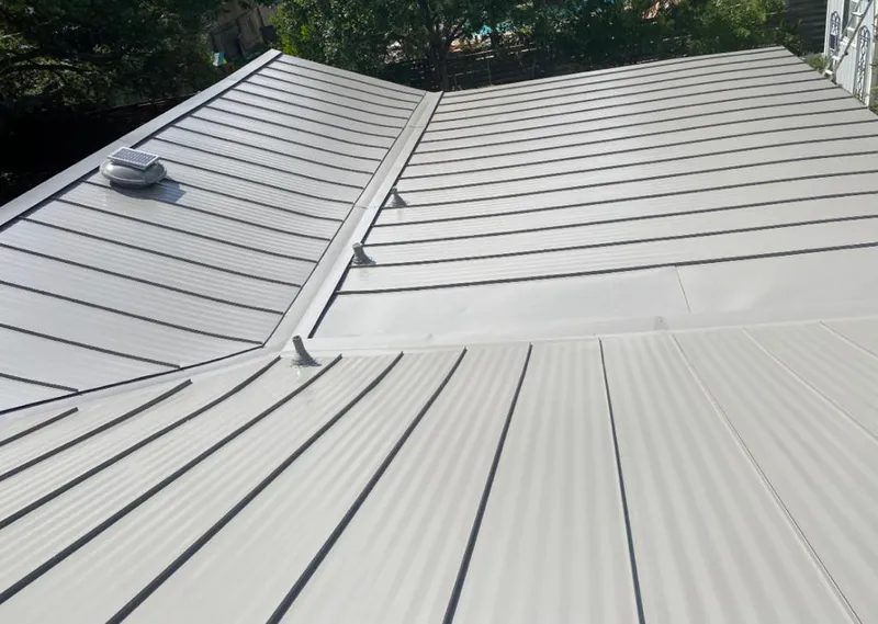 Solar attic fan installed on a metal roof for Roof Ventilation in Canton